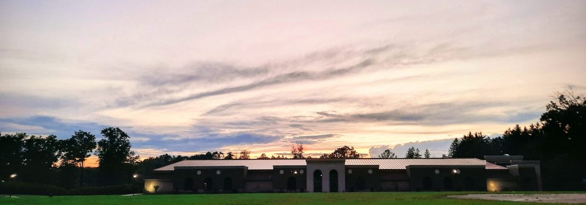 Clouds and sunset light behind recreation center building