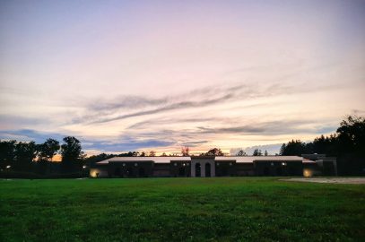 Clouds and sunset light behind recreation center building