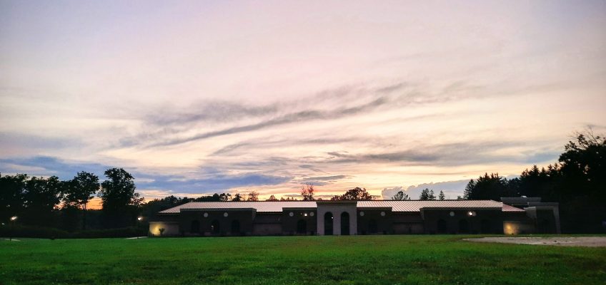 Clouds and sunset light behind recreation center building