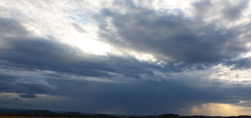 sky contrasting from bright sun and dark clouds